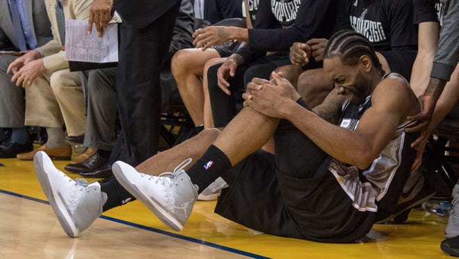 San Antonio Spurs forward Kawhi Leonard reacts after an injury during the third quarter in Game 1 of the Western conference finals.