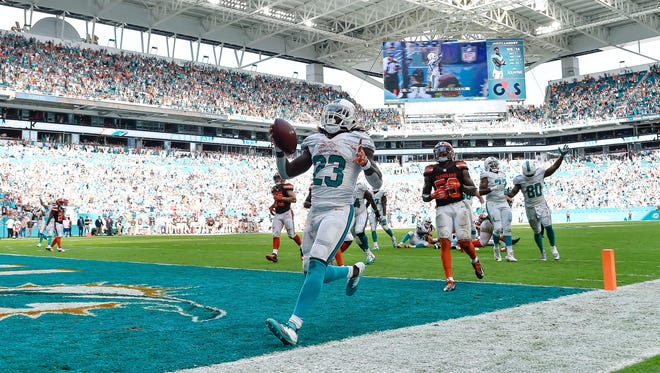 Dolphins running back Jay Ajayi (23) celebrates his game-winning touchdown in overtime against the Cleveland Browns.