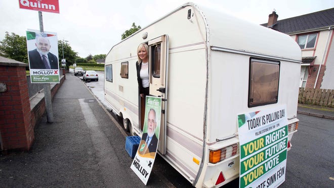 Sinn Fein's northern leader Michelle O'Neill poses in a Sinn Fein election campaign caravan after casting her vote at a polling station in Clonoe, west of Belfast.