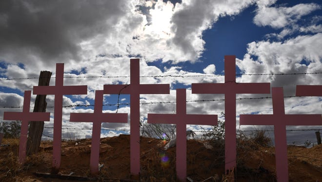 Crosses placed in memory of eight victims of feminicide which were found at Lomas del Poleo are pictured on Feb.19, 2017 in Ciudad Juarez, Chihuahua state, Mexico. This image is part of an ongoing Agence France-Presse photo project documenting life on both sides of the U.S./Mexico border simultaneously by two photographers traveling for 10 days from California to Texas between Feb. 13 and 22, 2017.