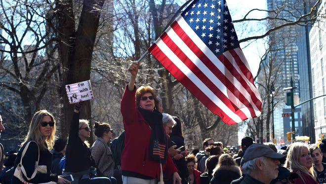Protestors march down Central Park West in New York during a 'Not My President's Day' rally.