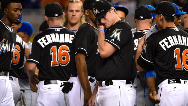 Marlins pitcher Tom Koehler wipes tears away after greeting all the New York Mets players at the pitchers mound in honor of the late Jose Fernandez.