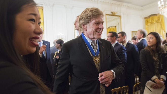 Actor Robert Redford leaves after President Barack Obama presented him with the Presidential Medal of Freedom.