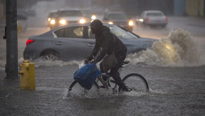 A bicyclist rides along a flooded street as a powerful storm moves across Southern California on Feb. 17, 2017 in Sun Valley, Calif.. After years of severe drought, heavy winter rains have come to the state, and with them, the issuance of flash flood watches in Santa Barbara, Ventura and Los Angeles counties, and the evacuation of hundreds of residents from Duarte, Calif. for fear of flash flooding from areas denuded by a wildfire last year.