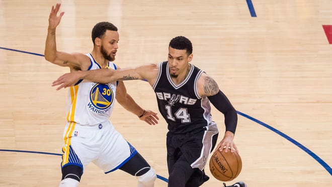 San Antonio Spurs guard Danny Green drives in against Golden State Warriors guard Stephen Curry during the first quarter in Game 1 of the Western Conference finals.