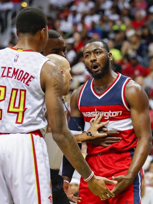John Wall reacts after being fouled by Kent Bazemore.