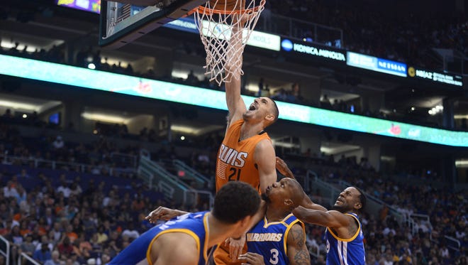 Alex Len is fouled as he attempts a dunk against the Warriors.