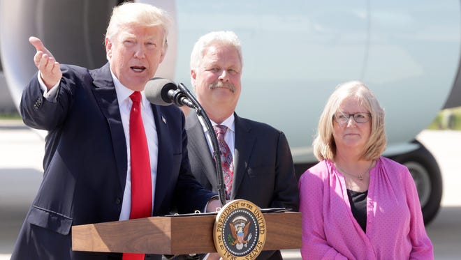 President Donald Trump speaks next to Robert Stoll, of Burlington, Wis., with his wife, Sarah, who Trump said were victims of the Affordable Care Act,  at 1919 E Grange Ave. near General Mitchell International Airport in Milwaukee.