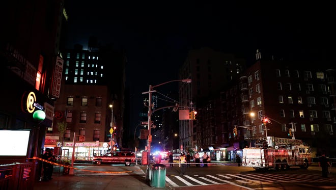 New York City Police and Fire Department officials respond to the scene of an explosion in Chelsea.