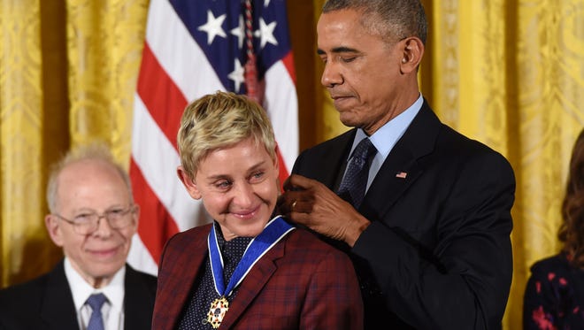 US President Barack Obama presents actress and comedian Ellen DeGeneres with the Presidential Medal of Freedom.