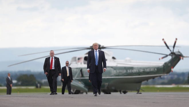 President Donald Trump walks across the tarmac before boarding Air Force One at Hagerstown Regional Airport, Aug. 18, 2017 in Hagerstown, Md. Trump is returning to Bedminister N.J., after having a meeting with his national security team at Camp David, Md. President  Trump is spending part of the summer at Trump National Golf Club in Bedminister.