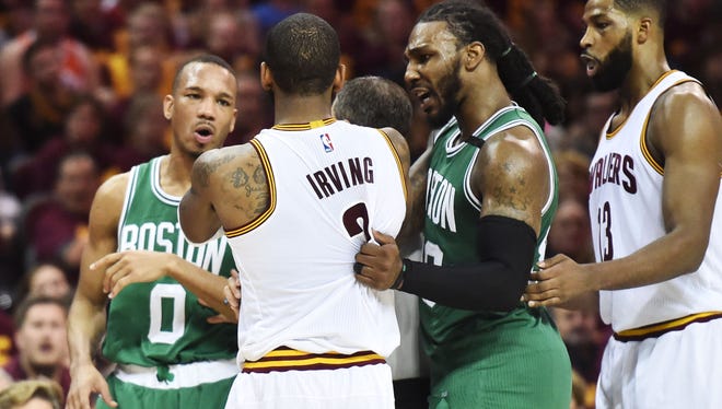 Boston Celtics forward Jae Crowder (99) holds back Cleveland Cavaliers guard Kyrie Irving (2) as he exchanges words with Boston Celtics guard Avery Bradley (0) during the second half in Game 3 of the Eastern Conference finals.