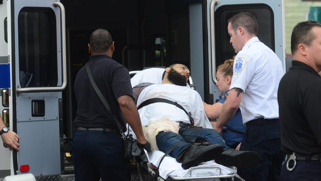 A man fitting the description of Ahmad Khan Rahami, 28, is loaded into the ambulance in Liden, N.J.