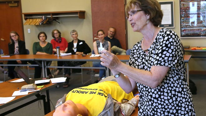 Lee Clay, education specialist with Health and Human Services of Waukesha County, shows how to use the Narcan nasal spray using a training dummy.
