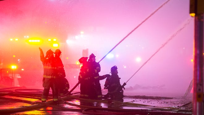 Firefighters work to extinguish the fire.