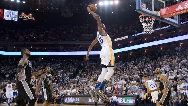 Kevin Durant soars for a dunk.