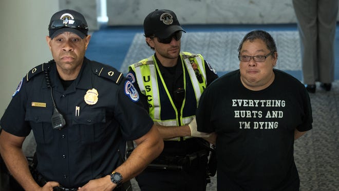 A protestor is arrested after lobbying against the Senate GOP health care bill in the office of Sen. Lisa Murkowski, R-Ark., on June 28, 2017 in Washington.