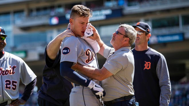 Apr 22, 2017; Minneapolis, MN, USA; Detroit Tigers trainer Kevin Rand, right, holds towels to JaCoby Jones' mouth after he was hit by a pitch in the third inning against the Minnesota Twins at Target Field.