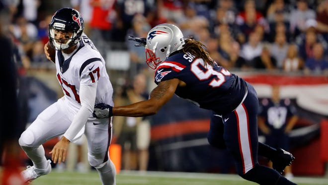 Houston Texans quarterback Brock Osweiler (17) is sacked by New England Patriots defensive end Jabaal Sheard (93) during the first half at Gillette Stadium.
