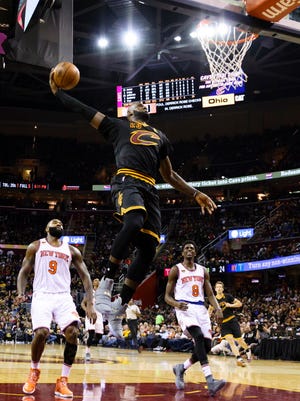 LeBron James (23) dunks in the first half during the Cavaliers' win against the Knicks.