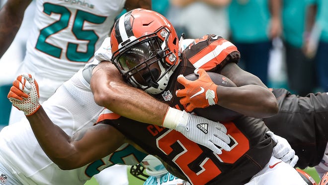 Cleveland Browns running back Duke Johnson (29) is tackled by Miami Dolphins outside linebacker Koa Misi (55) during the first half at Hard Rock Stadium.
