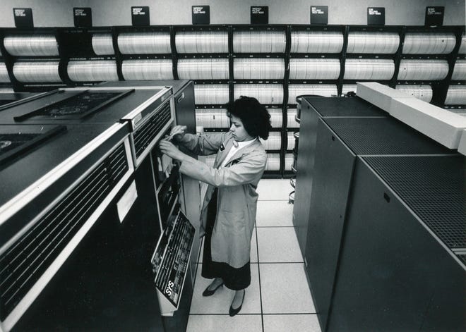 1988 - Black and white file photo - Karol Harris, a computer operator for CompuServe , works in the main computer room changing tapes.