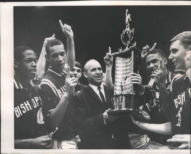 John Johnson (second from left) celebrates with his team and coach after Messmer won the 1966 WISAA state championship. He scored 69 points and had 64 rebounds in that year's tournament.