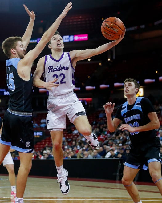 Kiel High School's Pierce Arenz (22) goes up for a layup over Lakeside Lutheran High School's Kooper Mlsna (15) in a Division 3 quarterfinal game during the WIAA state boys basketball tournament on Thursday, March 14, 2024 at the Kohl Center in Madison, Wis. Lakeside Lutheran won the game, 57-55.