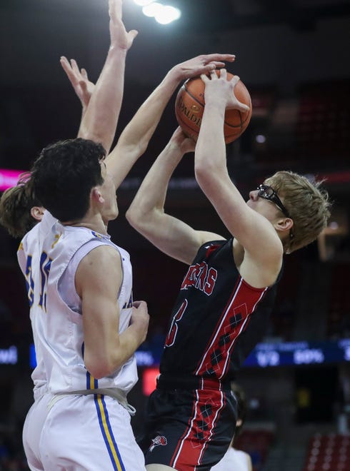 Marathon High School's Andrew Glennon (13) has his shot blocked by Kenosha St. Joseph Catholic Academy's Dominic Santarelli (23) and Lowell Werlinger (15) in a Division 4 semifinal game during the WIAA state boys basketball tournament on Thursday, March 14, 2024 at the Kohl Center in Madison, Wis. Kenosha St. Joseph Catholic won the game, 46-37.