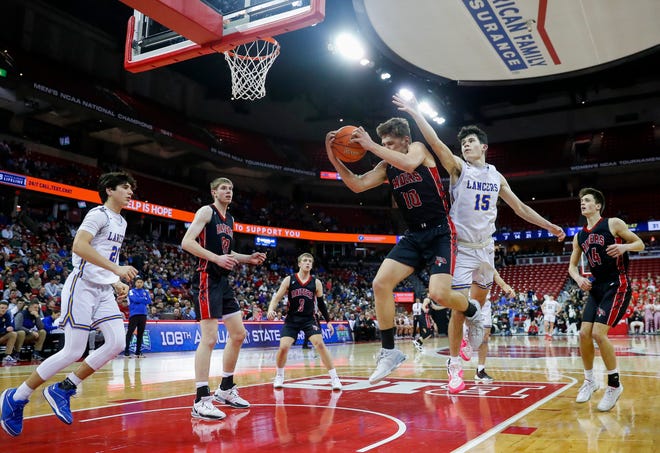 Marathon High School's Drew Woelfel (10) pulls down a rebound against Kenosha St. Joseph Catholic Academy's Lowell Werlinger (15) in a Division 4 semifinal game during the WIAA state boys basketball tournament on Thursday, March 14, 2024 at the Kohl Center in Madison, Wis. Kenosha St. Joseph Catholic won the game, 46-37.
