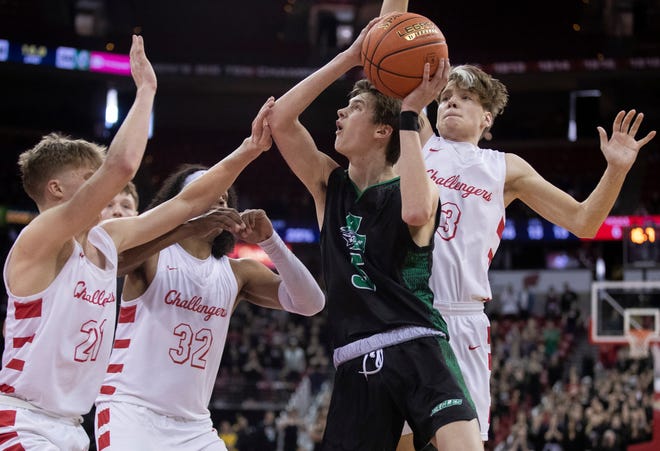 Almond-Bancroft High School's TJ Lamb (5) is fouled by Abundant Life Christian School's Jonah Koon (3) in a Division 5 semifinal game during the WIAA state boys basketball tournament on Friday, March 15, 2024 at the Kohl Center in Madison, Wis. Abundant Life Christian won the game, 42-37.