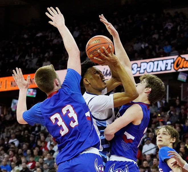 Nicolet's Davion Hannah (25) attempts to score pass Wisconsin Lutheran's Kon Knueppel (33) and Zavier Zens (23) during the first half of the WIAA Division 2 boys basketball state semifinal game on Friday March 15, 2024 at the Kohl Center in Madison, Wis.