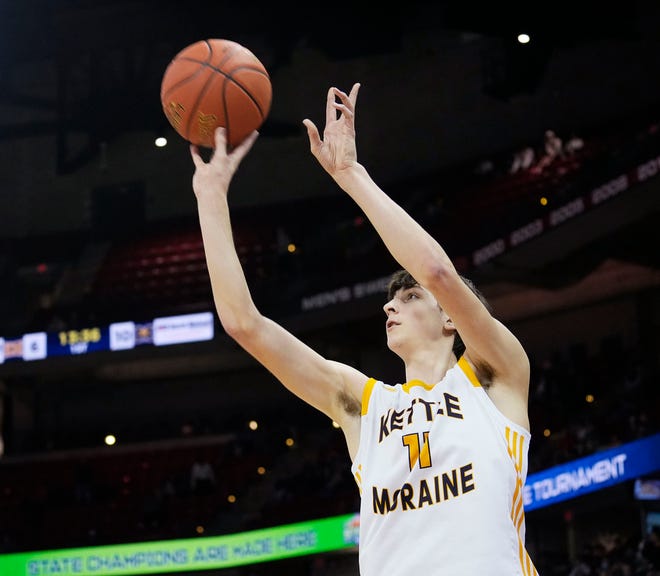 Kettle Moraine's Nathan Vuillaume (11) scores a three pointer during the first half of the WIAA Division 1 boys basketball state semifinal game against Marquette on Friday March 15, 2024 at the Kohl Center in Madison, Wis.