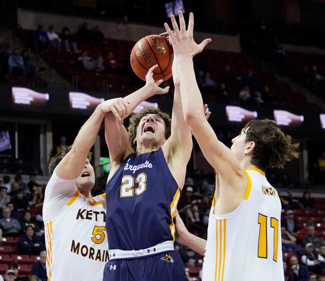 Kettle Moraine's Jon Ksobiech (5) fouls Marquette's Nolan Minessale (23) during the second half of the WIAA Division 1 boys basketball state semifinal game on Friday March 15, 2024 at the Kohl Center in Madison, Wis.