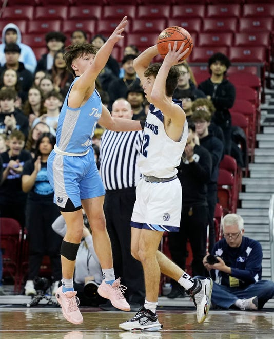 St. Thomas More's Kyle Alivo (1) attempts to block Lakeside Lutheran's Easton Wolfram (12) during the first half of the WIAA Division 3 boys basketball state championship game on Saturday March 16, 2024 at the Kohl Center in Madison, Wis.