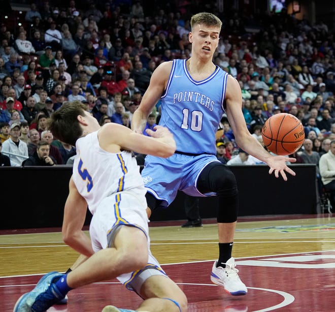 Kenosha St. Joseph's Tommy Santarelli (5) slips and Mineral Point's Eli Lindsey (10) gains possession of the ball during the second half of the WIAA Division 4 boys basketball state championship game on Saturday March 16, 2024 at the Kohl Center in Madison, Wis.