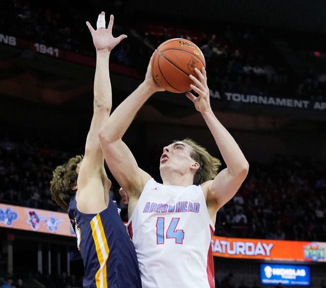 Arrowhead's Bennett Basich (14) drives to score but is blocked by Marquette's Nolan Minessale (23) during the first half of the WIAA Division 1 boys basketball state championship game on Saturday March 16, 2024 at the Kohl Center in Madison, Wis.