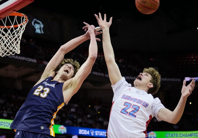 Marquette's Nolan Minessale (23) and Arrowhead's Andy Cochrane (22) attempt to gain possession of the rebound during the first half of the WIAA Division 1 boys basketball state championship game on Saturday March 16, 2024 at the Kohl Center in Madison, Wis.