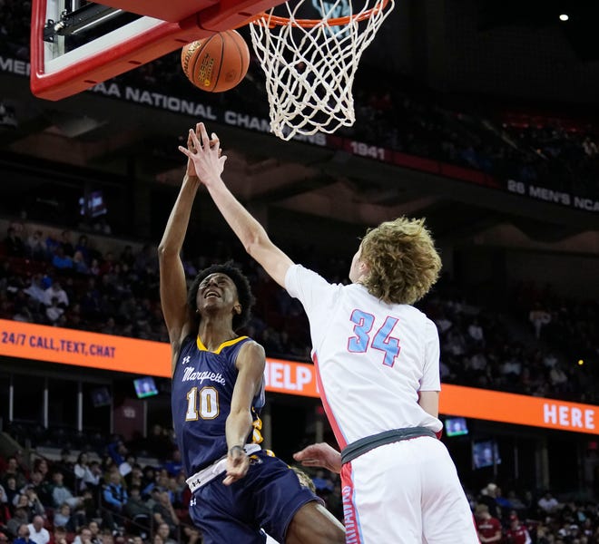 Arrowhead's AJ Ohrmundt (34) attempts to block Marquette's Jeremiah Johnson (10) during the second half of the WIAA Division 1 boys basketball state championship game on Saturday March 16, 2024 at the Kohl Center in Madison, Wis.