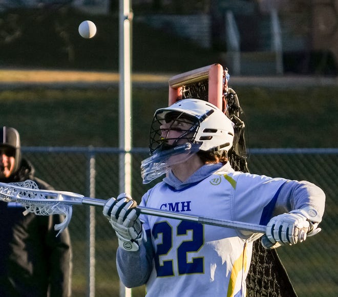 Catholic Memorial goalie Zach Bauer (22) blocks a shot during the lacrosse match at home against Cedarburg on Wednesday, March 20, 2024.