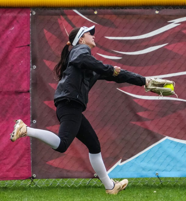 Arrowhead center fielder Jacquelyn Cox (11) makes a catch at the fence during the game at home against Oconomowoc, Tuesday, April 16, 2024.