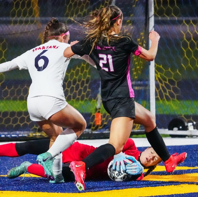 Brookfield East keeper Sam Schroeder (1) takes the ball away from Kettle Moraine's Eiley Henderson (21) during the match at Kettle Moraine, Thursday, April 18, 2024.