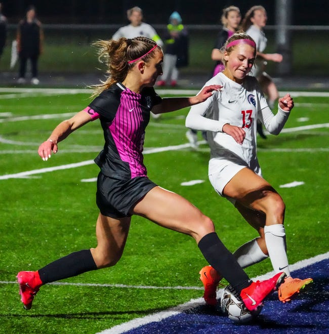 Brookfield East's Ella Schroeder (13) cuts off Kettle Moraine's Eiley Henderson (21) during the match at Kettle Moraine, Thursday, April 18, 2024.