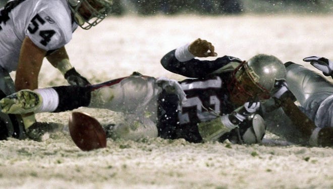 Brady loses the bull during the 2002 AFC Divisional Playoff game against Oakland. The fumble was overturned under the now-infamous "tuck rule."