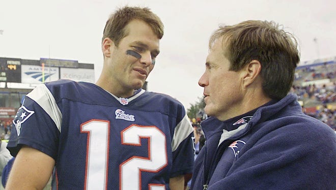 Brady is congratulated by Patriots coach Bill Belichick after New England beat the Colts 44-13 in Brady's first career start on Sept. 30, 2001.