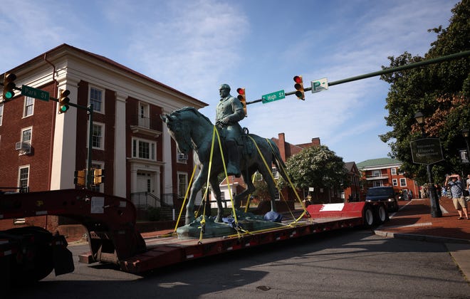 A flatbed truck carries a statue of Confederate General Robert E. Lee from the Market Street Park July 10, 2021 in Charlottesville, Virginia. Initial plans to remove the statue four years ago sparked the infamous “Unite the Right” rally where 32 year old Heather Heyer was killed. A statue of Confederate General Thomas "Stonewall" Jackson in the Charlottesville and Albemarle County Courthouse Historic District is also scheduled to be removed this weekend.