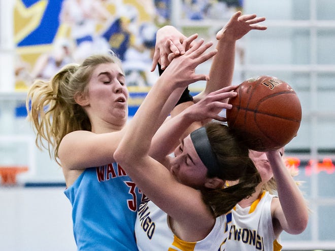 Arrowhead's Lauren With (left) battles for a rebound with Mukwonago's Angie Cera (22) and Dru Henning (33) during the game at Mukwonago on Friday, Jan. 4, 2019.