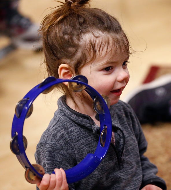 Carolie King, 3, plays a tambourine during a free parent and child music class on Jan. 17 offered by Nick Meske as a promotion for a six-week class he will be offering through the Oconomowoc Recreation Department at the Community Center.