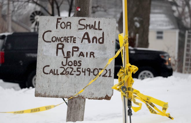 Police take remains near a sign advertising for small concrete and repair jobs at the scene of a home destroyed by fire at S15 W22398 Arcadian Ave. in the Town of Waukesha on Wednesday, Feb. 20, 2019. The early morning fire killed three people, and injured three others on Tuesday, Feb. 19.